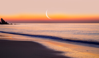 Abstract background of amazing crescent moon over the sea at sunset