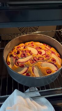 Homemade seasonal fruit pie with cherry, nectarine and lemon taken out of oven, cozy aromatic baking