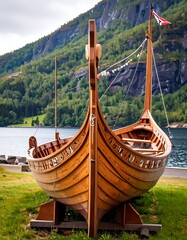 Wooden Viking-style longship on grassy shore