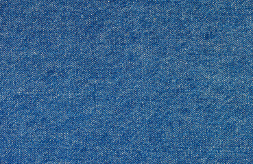 Abstract texture background of classic blue jeans denim fabric. A macro detail showing the distinctive diagonal twill weave and fibers of the material, ideal for fashion and design concepts