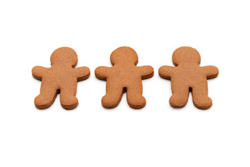 Three gingerbread cookies in shape of men isolated on white background