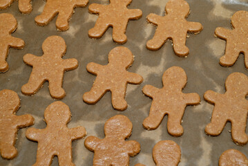 Raw gingerbread men cookies on baking sheet ready for oven