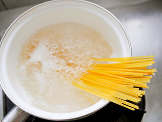 Dried capellini spaghetti in boiling water