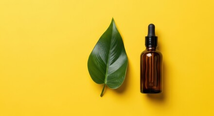 Natural Ingredient Essential Oil Dropper Bottle with Leaf on Yellow Background