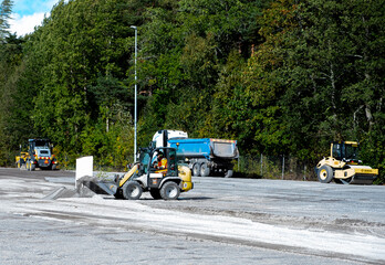 Road repair, vehicles and bulldozer paving.