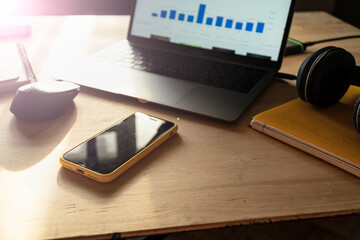 Modern freelancer desk setup with laptop, smartphone, and headphones. Concept of remote work, home office