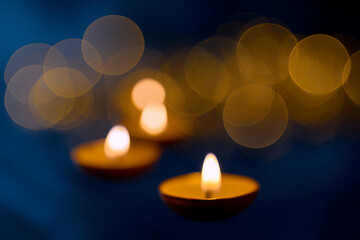 Diwali theme background with abstract golden bokeh, faint diya shapes, deep indigo backdrop, 