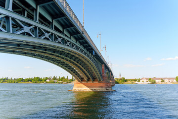 Fototapeta premium Bridge Arching Over the Rhine River in Mainz Against a Clear Blue Sky