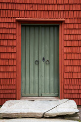  Vibrant Red Tiled Green Door against a Backdrop of Trankils Church in Årjäng, Sweden Keywords: Trankils church, Arajang, Sweden, Green door, Red tiles, Wooden tiles, Architecture, Religious