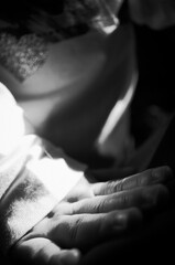Close-up detail of baby hand with blurred background in black and white