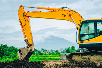 Excavator on limestone mountain. Backhoe digging sand, soil on limestone mountain, Heavy construction equipment is digging at construction site. Excavator is working on soil, foundation. Road construc