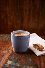 Cup of coffee on rustic wooden background. Soft focus. Copy space	