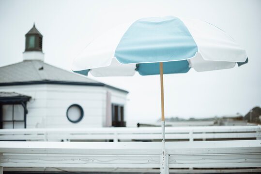 Striped open parasol outside a public waterfront building, Malibu, California, USA