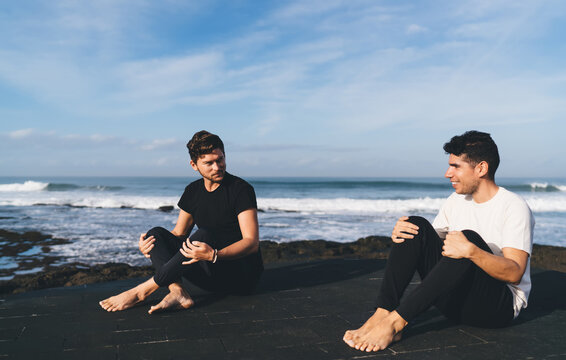 Yoga conversation between two men symbolizes mindful dialogue and digital decompression, embodying real connection and emotional balance beyond the virtual world.