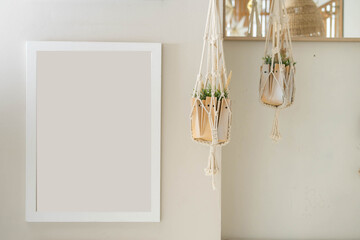 White picture frame mockup and home decor on table. Scandinavian living room interior design. Nordic style.