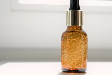 Natural oil cosmetics. Dropper glass amber Bottle Mock-Up. Oily cosmetic pipette. Face and body treatment. Spa concept. Mineral organic liquid. Front view. Beauty products. Blank packaging on white.