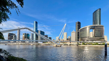 View into land from the South Bank of the city skyline, Neville Bonner Bridge and reflections in the Brisbane River, Brisbane, Queensland, Australia