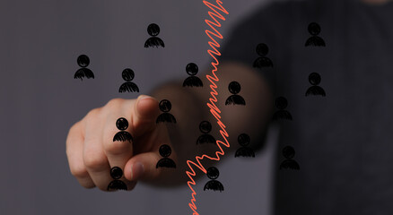 Hand pointing at falling graph, symbolizing job cuts, economic downturn, and workforce reduction.