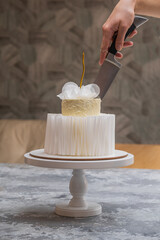 Luxury multi-tiered festive wedding cake. Elegant dessert for wedding celebration. Party cake being cut. Useful for brochures, wedding planners, postcards, wedding inspiration