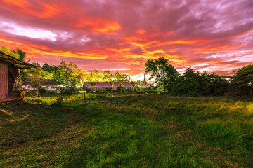 The background of the twilight sunset, the sky has beautiful changes, amidst the green fields and various trees, there is a cool breeze blowing throughout the journey to the viewpoint.