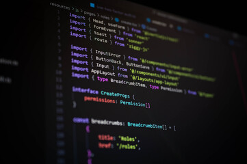 Close-up of TypeScript code on dark editor screen showing module imports, interface declarations, and frontend components, ideal for concepts of web app development, UI frameworks, and coding design.