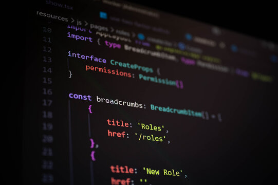 Close-up of TypeScript code with breadcrumb navigation logic on a dark screen, representing frontend web development, UI routing, TypeScript interfaces, and clean code architecture in modern apps.