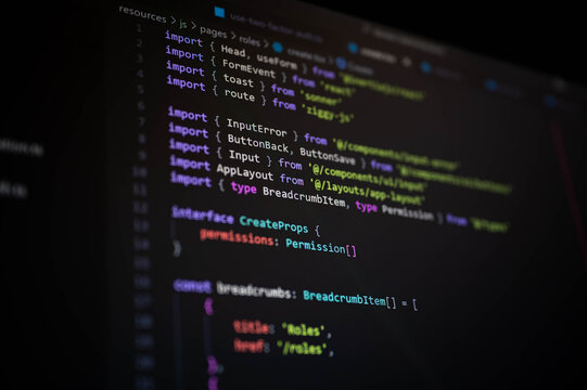 Close-up of TypeScript code on dark editor screen showing module imports, interface declarations, and frontend components, ideal for concepts of web app development, UI frameworks, and coding design.