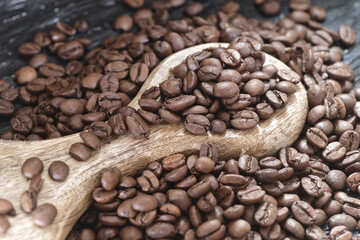 Coffee beans on the dark wooden background