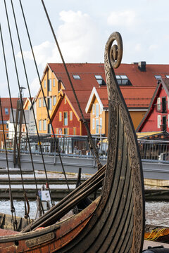 Reconstructed Oseberg viking ship and brightly-coloured traditional Norwegian timber merchants' houses at the harbor of Tonsberg.