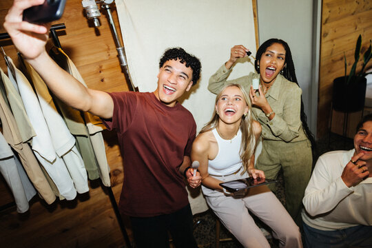 Friends enjoying creative collaboration during social photo and video session