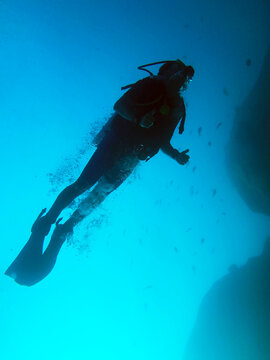 Low angle view of a woman scuba diving in the Adaman Sea, Similan Islands, Thailand