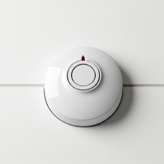 Smoke detector mounted on white wall in modern design  