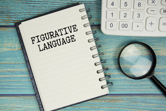 Figurative Language text on notepad with magnifying glass and calculator on wooden background