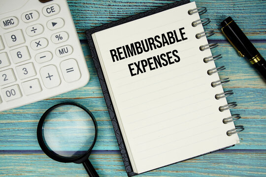 Reimbursable Expenses text on notepad with magnifying glass and calculator on wooden background