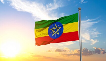 "A striking image of Ethiopia&rsquo;s flag waving at sunrise or sunset, with green, yellow, and red horizontal stripes and a central blue emblem symbolizing unity and diversity."