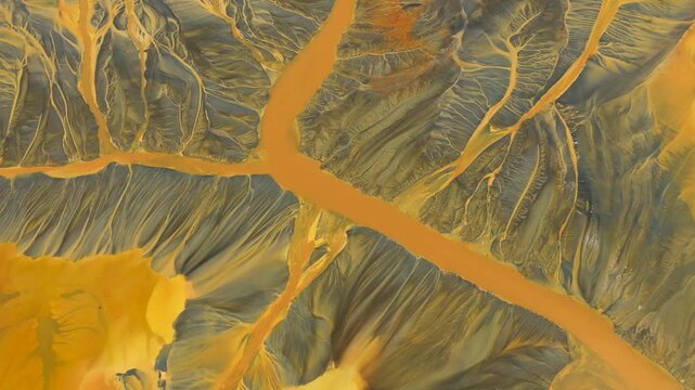 Shadow covering aerial view of colorful contaminated cyanide residuals waters from gold mine. Abstract nature pattern