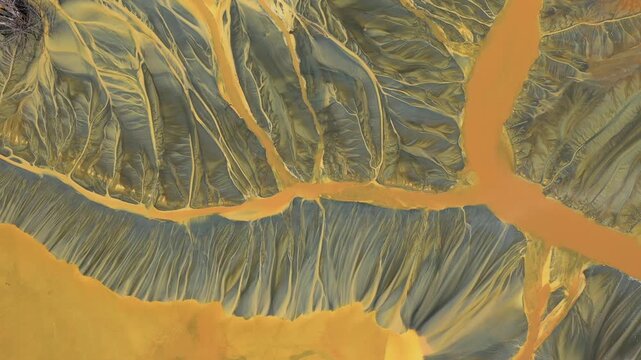 Shadow covering aerial view of colorful contaminated cyanide residuals waters from gold mine. Abstract nature pattern