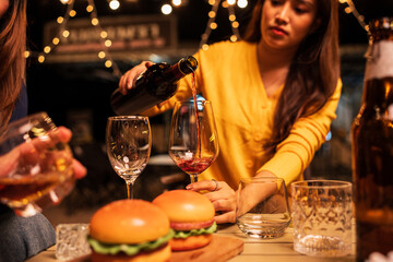 Group of Asians are having a celebration at a restaurant with drinks.