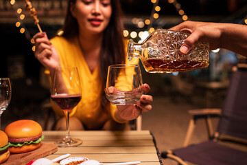 Group of Asians are having a celebration at a restaurant with drinks.