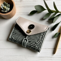 Handmade grey crochet wallet placed on a table, combining cozy craftsmanship with stylish, functional design for everyday use.