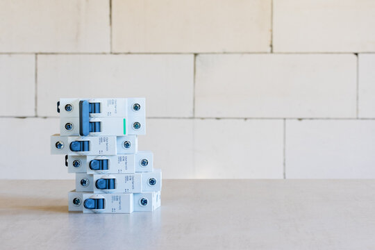 A set of new automatic electrical switches on the background of a white wall with a copy space