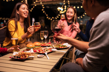 Group of Asians are having a celebration at a restaurant with drinks.