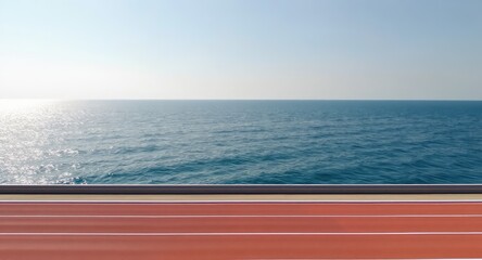 Ocean Running Track.  Calm sea stretches out, framed by a red track