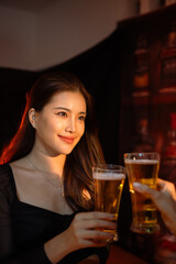 food and drink male friends are happy drinking beer and clinking glasses at a bar or pub.