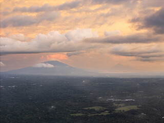 Mountains and clouds at dusk over lush green landscape