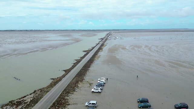 Aerial view of oyster farms at low tide near the Passage du Gois, Noirmoutier Island, France. Long rows of oyster beds and water channels create a unique landscape, showcasing traditional oyster
