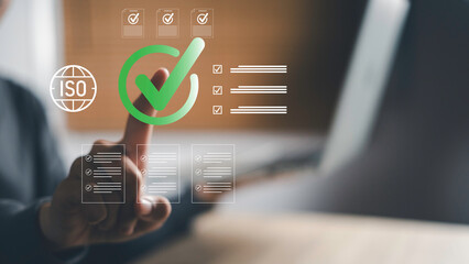 Businessman pointing at digital ISO certification checklist icon, symbolizing compliance standards, quality assurance, process validation, and business certification in modern organizations.