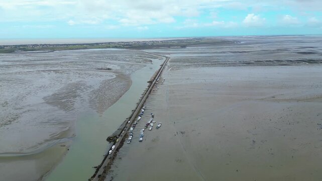 Aerial view of oyster farms at low tide near the Passage du Gois, Noirmoutier Island, France. Long rows of oyster beds and water channels create a unique landscape, showcasing traditional oyster
