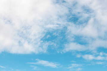 Bright blue sky with fluffy white clouds visible during a sunny day in early afternoon
