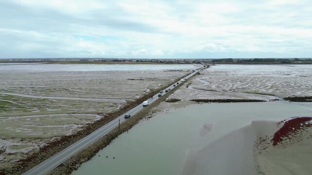 Aerial view of oyster farms at low tide near the Passage du Gois, Noirmoutier Island, France. Long rows of oyster beds and water channels create a unique landscape, showcasing traditional oyster
